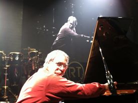Paul Wesley performing at a concert piano